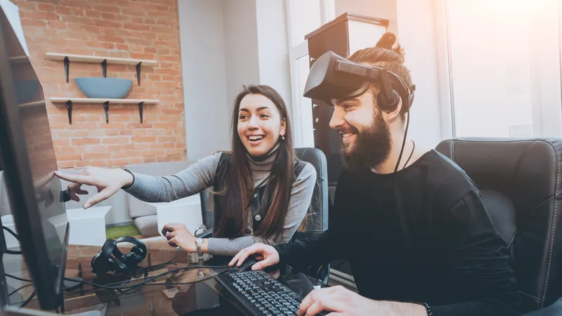 shutterstock_572840395 Male and Female designer with VR headset on